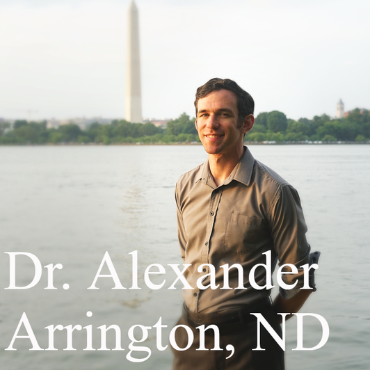 Photo of Dr. Arrington standing in front of the Washington Monument in the District of Columbia